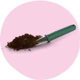 Green handled trowel with soil